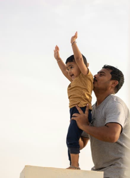 Father lifting child